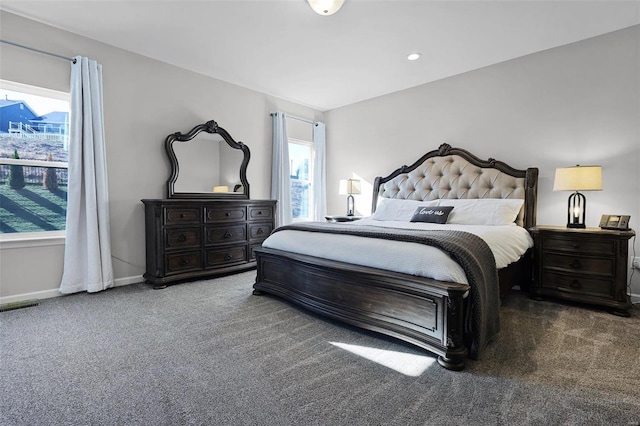 carpeted bedroom featuring multiple windows