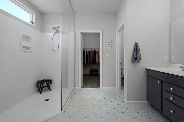 bathroom featuring vanity, toilet, and walk in shower