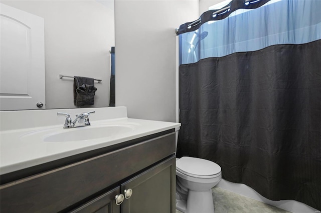 bathroom featuring tile patterned flooring, vanity, and toilet