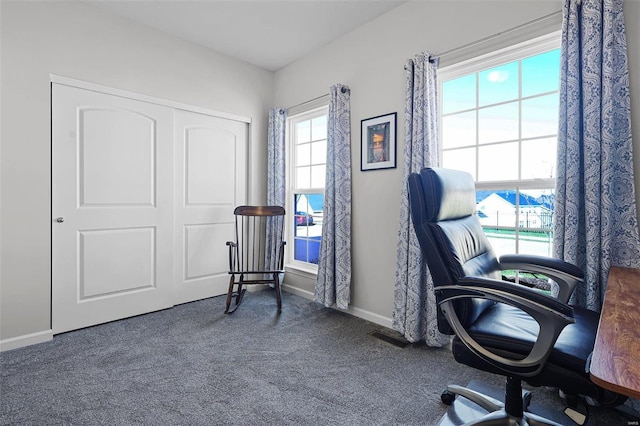 office area with dark colored carpet and a wealth of natural light