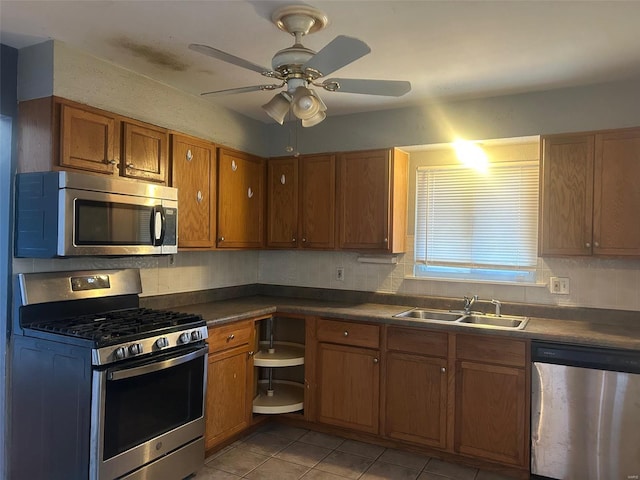 kitchen featuring ceiling fan, sink, light tile patterned floors, and appliances with stainless steel finishes