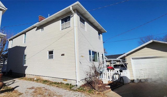 view of side of home featuring a garage