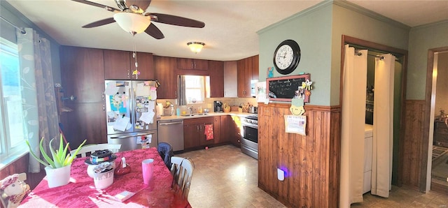 kitchen with ceiling fan, ornamental molding, sink, and appliances with stainless steel finishes