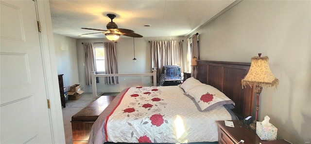 bedroom with ceiling fan and ornamental molding