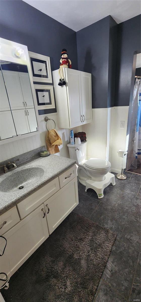 bathroom featuring vanity and toilet