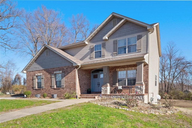 craftsman inspired home featuring a front yard and a porch