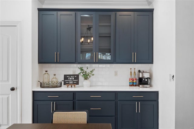 bar featuring blue cabinetry and tasteful backsplash