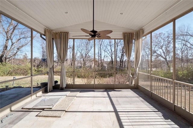 unfurnished sunroom featuring plenty of natural light, ceiling fan, wood ceiling, and lofted ceiling