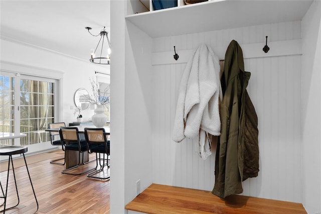 mudroom featuring a chandelier and hardwood / wood-style floors