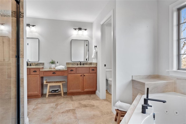 bathroom featuring a bathing tub, vanity, and toilet