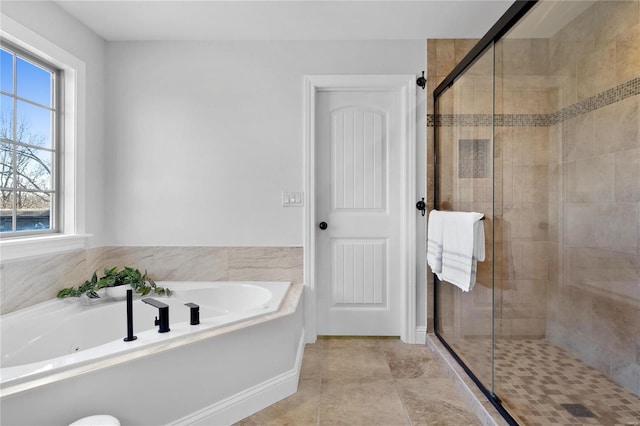 bathroom with tile patterned floors and independent shower and bath