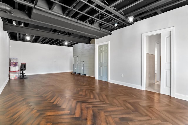 unfurnished living room with dark parquet floors