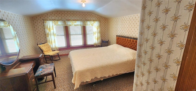 bedroom with carpet floors and vaulted ceiling