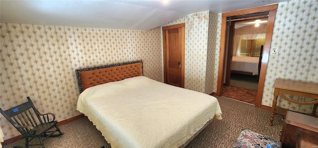 carpeted bedroom with a closet and vaulted ceiling