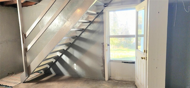 stairway featuring concrete flooring