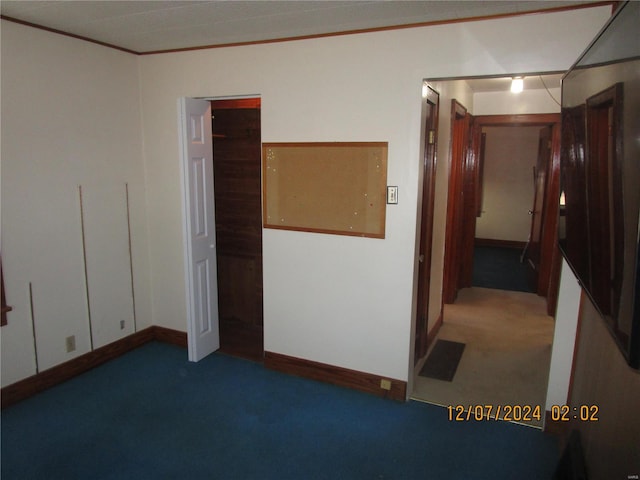 interior space featuring ornamental molding and carpet