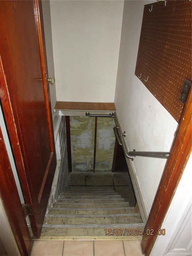 staircase with tile patterned flooring