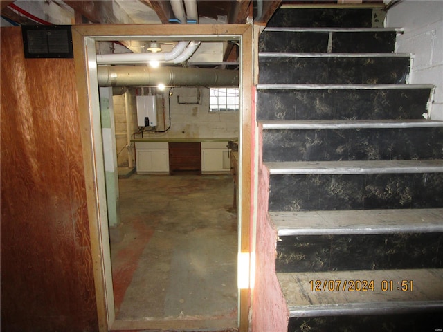 basement featuring tankless water heater