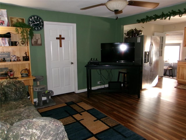 living room with ceiling fan and dark wood-type flooring