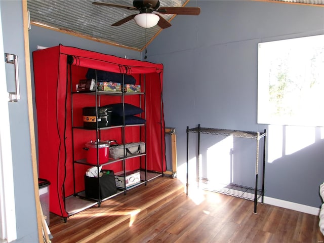 interior space featuring ceiling fan, dark hardwood / wood-style flooring, and lofted ceiling