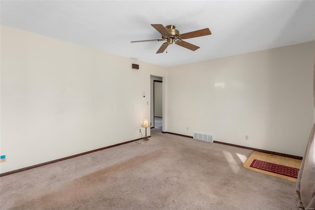 spare room featuring ceiling fan and light colored carpet