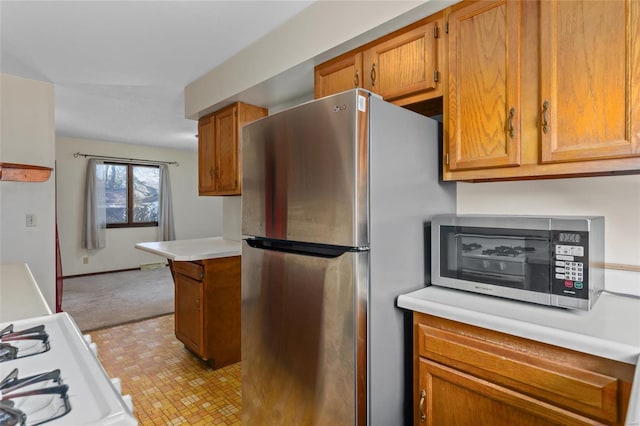 kitchen with stainless steel fridge, white gas range oven, and light carpet