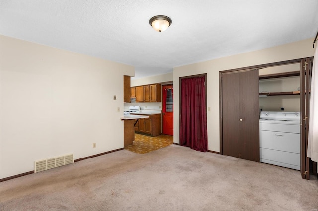 interior space with light carpet and washer / dryer