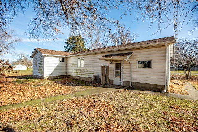 single story home featuring central AC unit and a front lawn