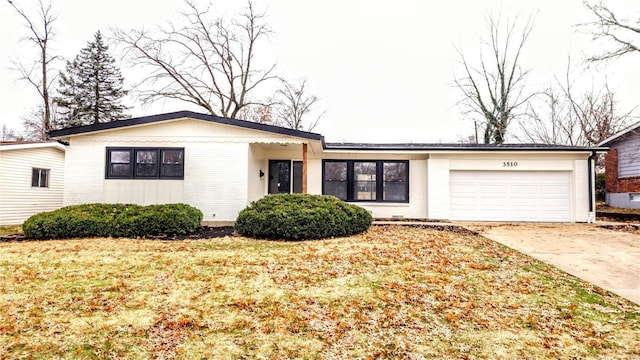 ranch-style house with a front yard and a garage