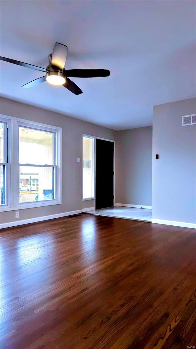 spare room with ceiling fan and dark wood-type flooring