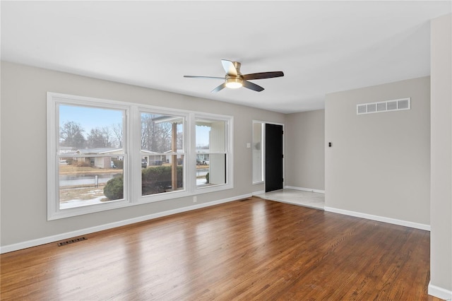 empty room featuring wood-type flooring and ceiling fan