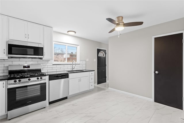 kitchen featuring sink, white cabinets, backsplash, ceiling fan, and stainless steel appliances