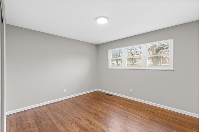 unfurnished room featuring hardwood / wood-style floors