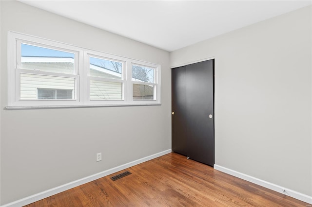 spare room with hardwood / wood-style flooring