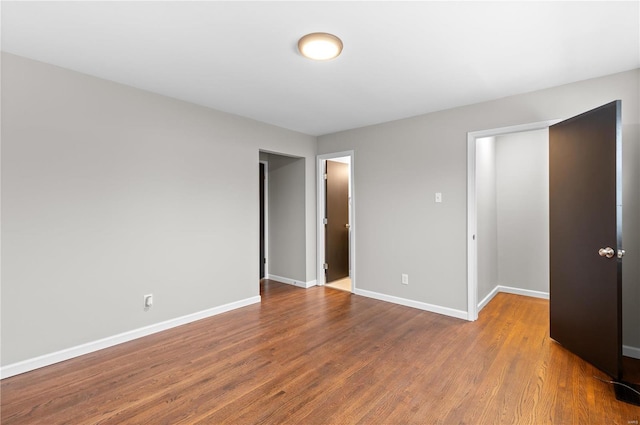 unfurnished bedroom with hardwood / wood-style flooring