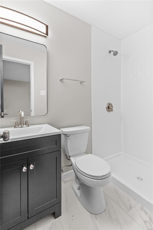 bathroom with vanity, a shower, and toilet