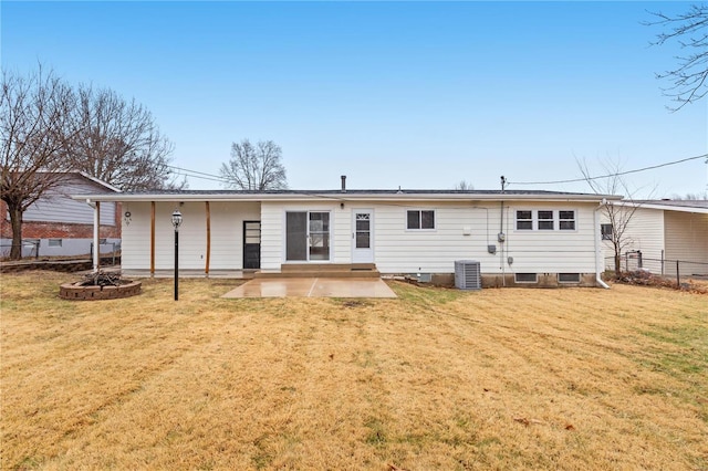 rear view of house with a patio area, central air condition unit, and a lawn