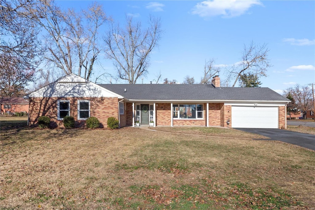 single story home featuring a garage and a front lawn