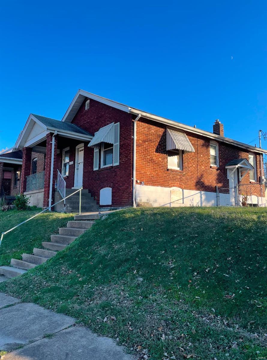 view of side of home featuring a lawn