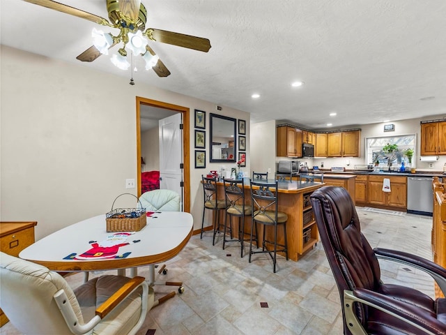 dining room featuring a textured ceiling and ceiling fan