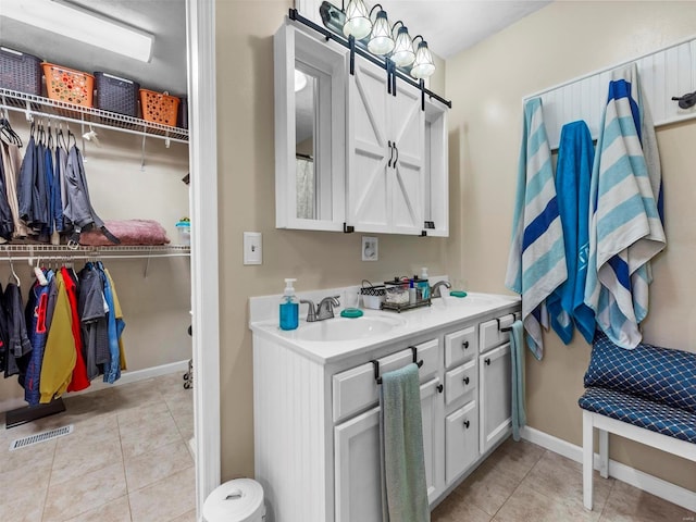 bathroom featuring tile patterned flooring and vanity