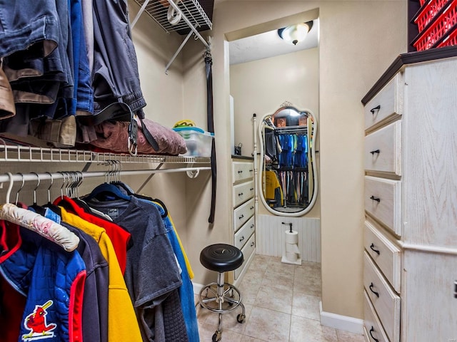 walk in closet with light tile patterned floors