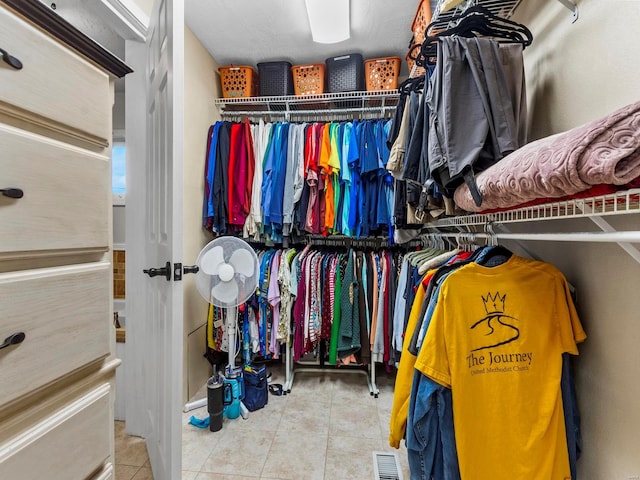 spacious closet with tile patterned floors