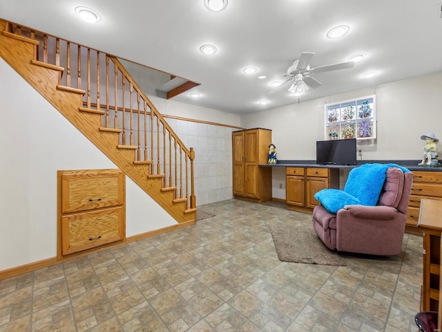 interior space with ceiling fan