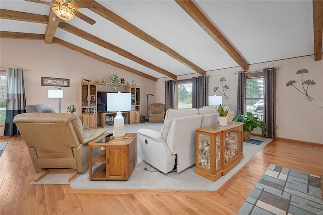 living room with vaulted ceiling with beams, ceiling fan, and light hardwood / wood-style flooring