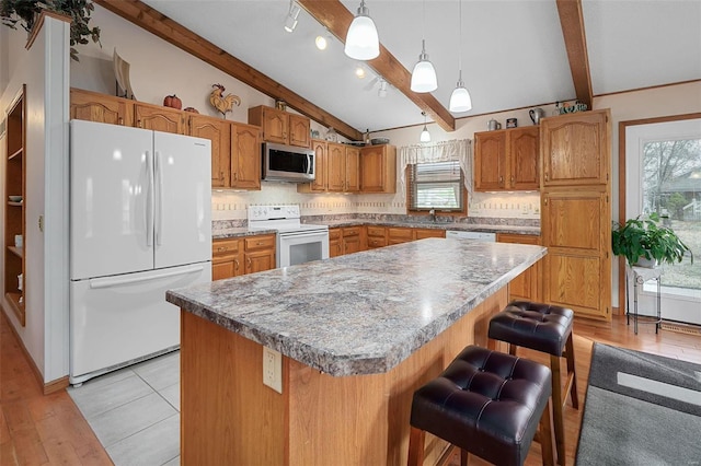 kitchen with a center island, vaulted ceiling with beams, light hardwood / wood-style floors, and white appliances