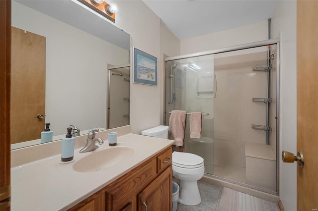 bathroom featuring tile patterned flooring, vanity, toilet, and walk in shower