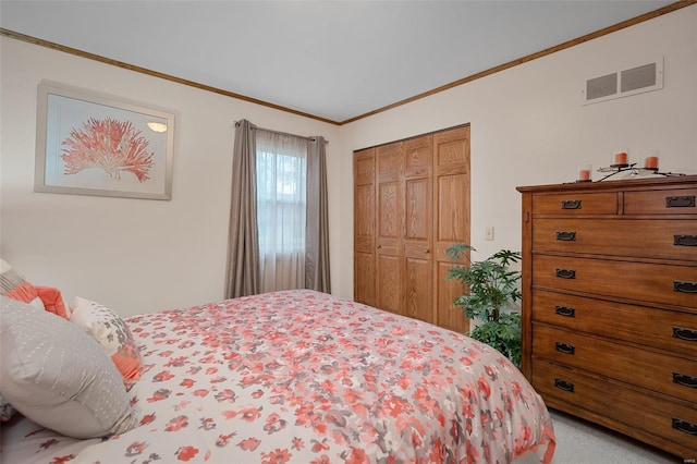 carpeted bedroom with a closet and crown molding