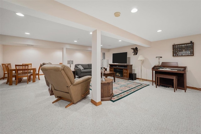 carpeted living room with beamed ceiling