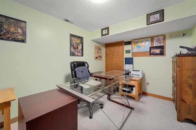 office space featuring light carpet and a textured ceiling